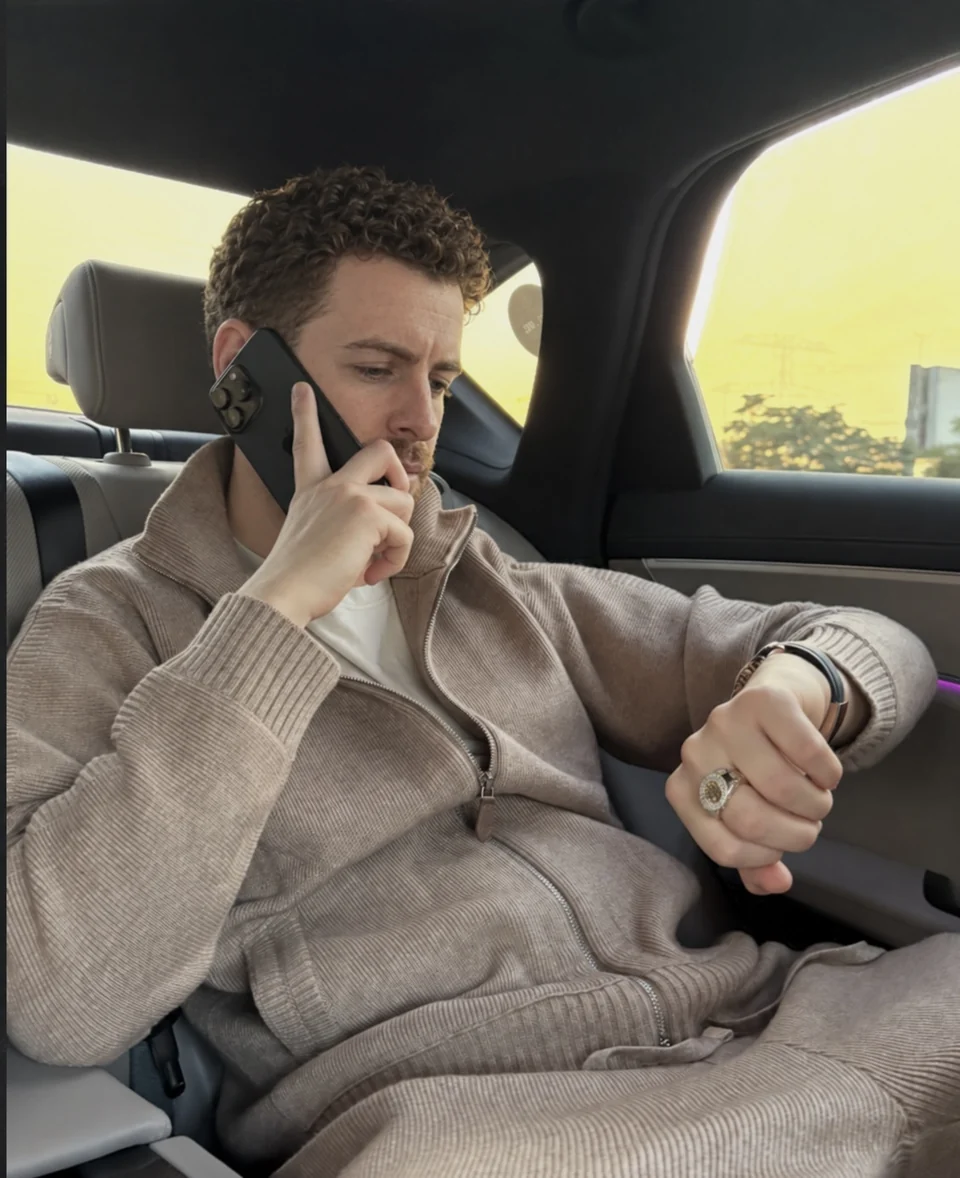 Joseph taking a phone call while travelling in a car